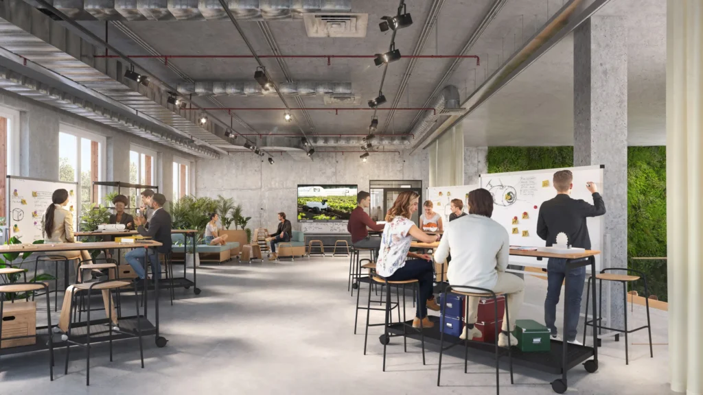 Workshop- und Kreativraum der TechFactory Garbsen 2045 mit flexiblen Arbeitsinseln, Whiteboards, Pflanzen und kollaborativer Gruppenarbeit.